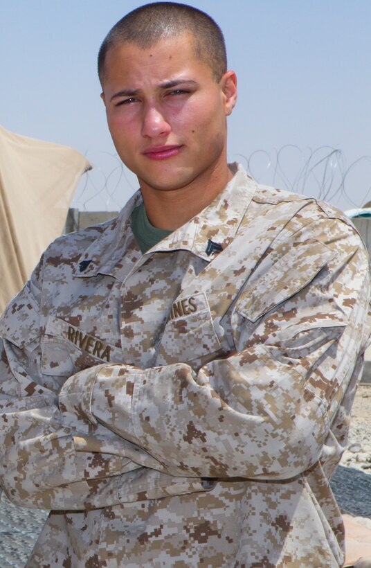 Cpl. Randy Rivera, an intelligence analyst with 3rd Marine Aircraft Wing (Forward), poses for a photo in the 3rd MAW (FWD) compound here, Aug. 13. Rivera was raised in the projects in Bronx, N.Y, which is arguably one of the roughest places to live in America. Rivera was involved with, and fell victim to, much of the gang-related violence in the area. However, he overcame his situation and joined the Marine Corps at 18. Rivera is currently serving on his second deployment.