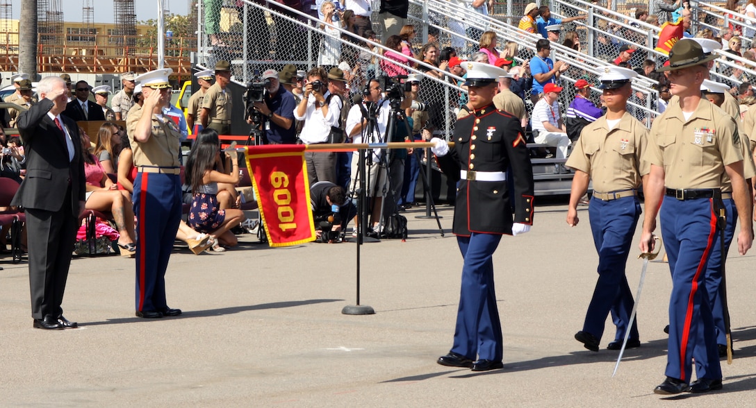 Dr. Robert M. Gates, secretary of defense, United States, and SIR salutes Platoon 1009, Company A, guidon as they execute a drill technique, pass and review, on Shepherds Drill Field, before being dismissed from graduation Aug. 13.