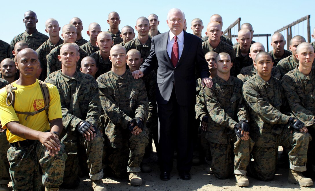 Dr. Robert M. Gates, secretary of defense, United States, stands with recruit s and a drill instructor from Company E, 2nd Battalion Recruit Training Regiment, Marine Corps Recruit Depot San Diego, after observing recruits training in the combat conditioning course at the depot Aug 13. This was included in Gates’ two day visit in southern California.