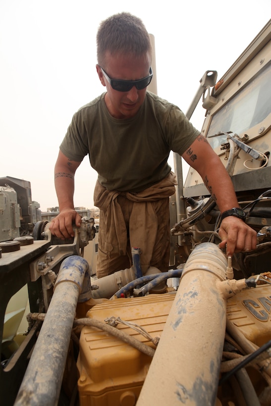 Lance Cpl. Keith J. Medlin, motor transport mechanic with Combat Logistics Regiment 15 (Forward), 1st Marine Logistics Group (Forward), tightens a bolt on an engine of a 7-ton truck at Forward Operating Base Dwyer, Afghanistan, Aug. 13. Medlin, 25, from Lugoff, S.C., is a Marine reservist who worked as a car dealership mechanic before deploying to Afghanistan. While deployed, Medlin used his knowledge to help fellow Marines improve their skills as mechanics, and developed a quicker way to repair the engine of a 7-ton truck.