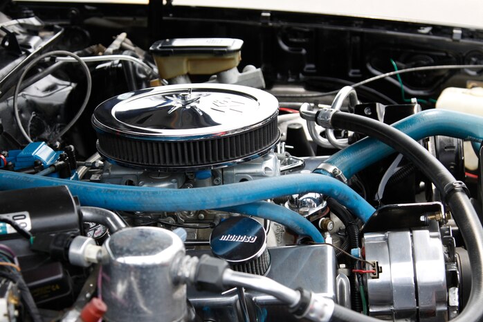 The hood of a custom built 1969 El Camino stands propped open to show off its engine to the public during the Iwakuni Wheels car and motorcycle show held at the Crossroads Mall here Aug. 14. The car show also featured motorcycles, food, a kid’s land with bounce houses, live music and dancing.