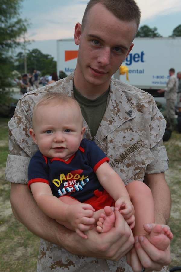 Cpl. Wacey Lanier holds his nine-month-old son, Kinser, at the Camp LeJeune Bitz Elementary School Aug. 12 after returning from a seven-month deployment. Lanier, is a data network specialist with Command Element, 24th Marine Expeditionary Unit.