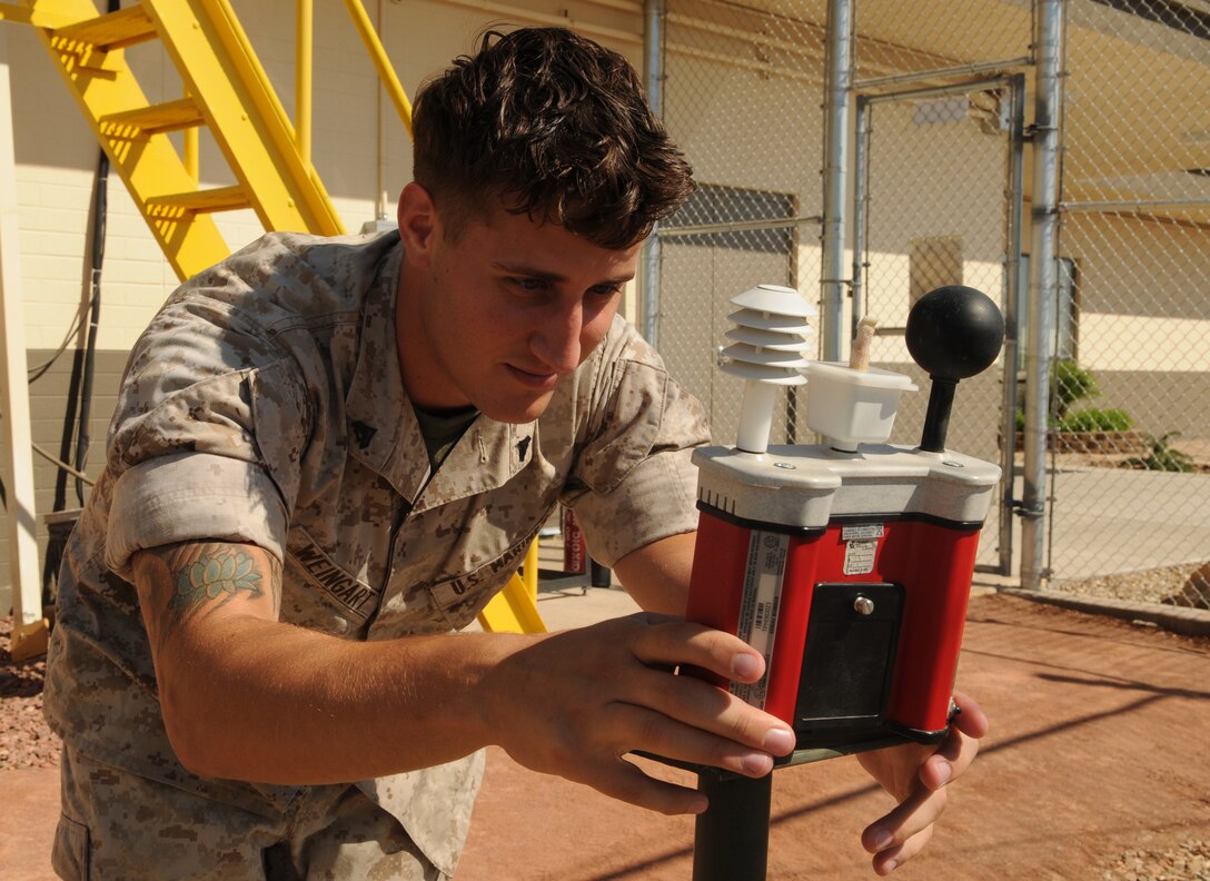 Cpl. Bryan Weingart, station weather observer, examines readings from a thermal environment monitor to determine the wet-bulb globe temperature index at the Marine Corps Air Station in Yuma, Ariz., Aug. 13, 2010. Weingart and 11 other meteorological and oceanographic Marines will be transferring from Marine Wing Support Squadron 371 to Marine Air Control Squadron 1’s Detachment C as part of a Corpswide move to better align METOC Marines with air traffic control squadrons.