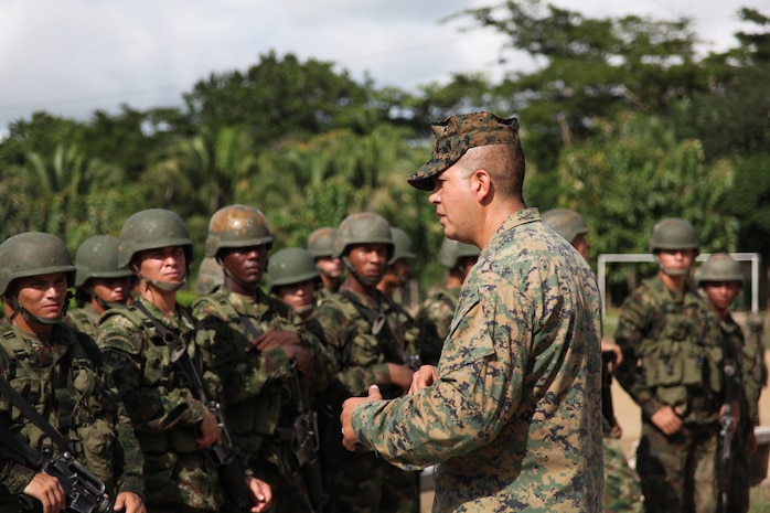 Staff Sgt. Gabriel Delarosa, native of Holland, Mich., and section leader of Company A, 2nd Assault Amphibian Battalion, Ground Combat Element of Special-Purpose Marine Air-Ground Task Force Continuing Promise 2010, gives a class to Colombian Marines about non-lethal weapons tactics at Colombian Marine Corps Training Base Covenas in Colombia, Aug. 14, 2010. Marines from USS Iwo Jima conducted subject matter expert exchanges with Colombian Marines Aug. 9-17 in support of Operation Continuing Promise 2010.