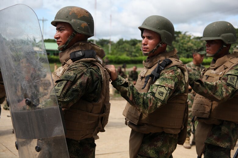 Colombian Marines suited in U.S. Marine Corps gear form up for non-lethal weapons training given by Marines with Company A, 2nd Assault Amphibian Battalion, Ground Combat Element of Special-Purpose Marine Air-Ground Task Force Continuing Promise 2010 at Colombian Marine Corps Training Base Covenas in Colombia, Aug. 14, 2010. Marines from USS Iwo Jima conducted subject matter expert exchanges with Colombian Marines Aug. 9-17 in support of Operation Continuing Promise 2010.