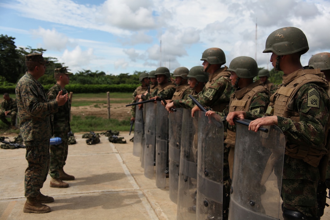 Staff Sgt. Gabriel Delarosa, native of Holland, Mich., and section leader of Company A, 2nd Assault Amphibian Battalion, Ground Combat Element of Special-Purpose Marine Air-Ground Task Force Continuing Promise 2010, gives a class to Colombian Marines about non-lethal weapons tactics at Colombian Marine Corps Training Base Covenas in Colombia, Aug. 14, 2010. Marines from USS Iwo Jima conducted subject matter expert exchanges with Colombian Marines Aug. 9-17 in support of Operation Continuing Promise 2010.