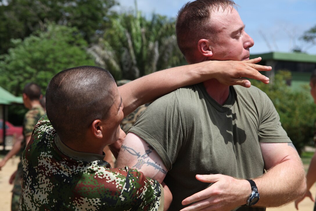 A Colombian Marine executes a non-lethal weapon takedown technique on Gunnery Sgt. Miles S. Beasley, native of Spokane, Wash., and platoon sergeant of Company A, 2nd Assault Amphibian Battalion, Ground Combat Element of Special-Purpose Marine Air-Ground Task Force Continuing Promise 2010, during non-lethal weapons training at Colombian Marine Corps Training Base Covenas in Colombia, Aug. 14, 2010. Marines from USS Iwo Jima conducted subject matter expert exchanges with Colombian Marines Aug. 9-17 in support of Operation Continuing Promise 2010.