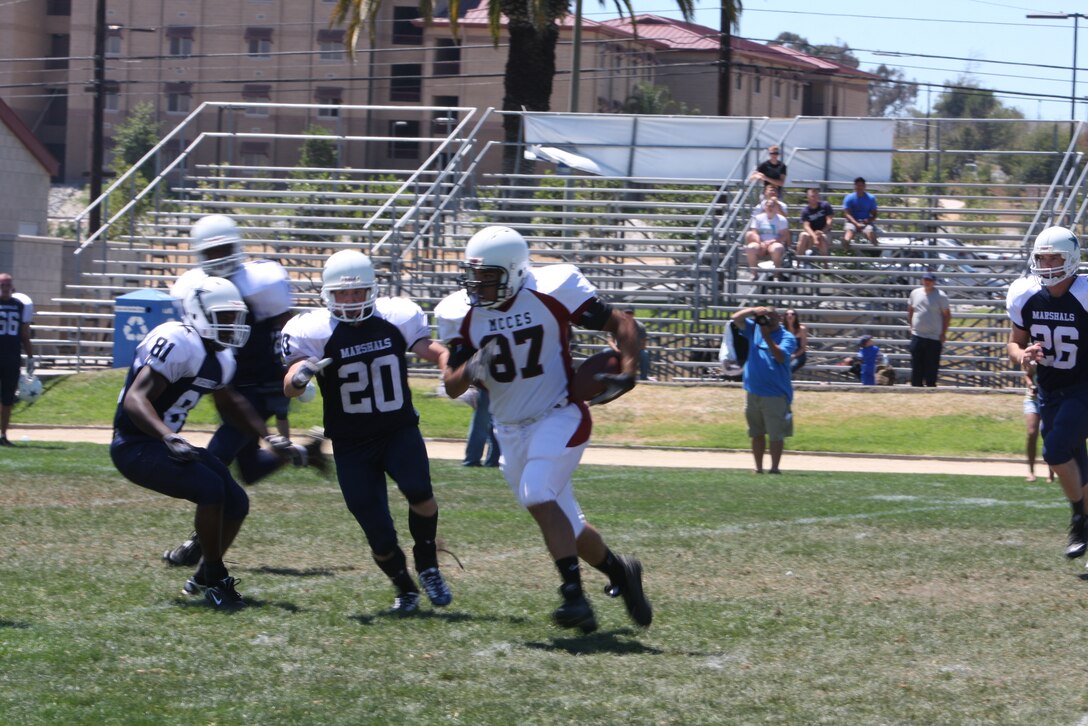MARINE CORPS BASE CAMP PENDLETON, Calif. – The Mustangs charge the Marshals as they kick-off the preseason with a scrimmage game at Marine Corps Base Camp Pendleton, Calif., at the 11-Area football field Aug. 14.
