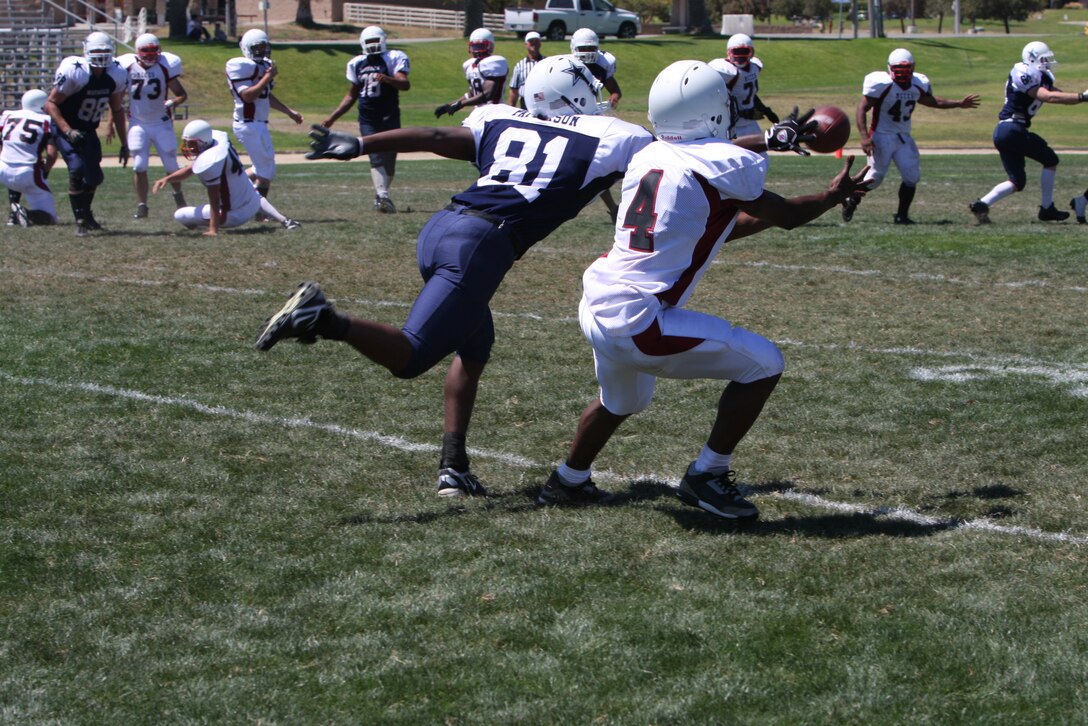 The Mustangs charge the Marshals as they kick-off the preseason with a scrimmage game at Marine Corps Base Camp Pendleton, Calif., at the 11-Area football field Aug. 14.