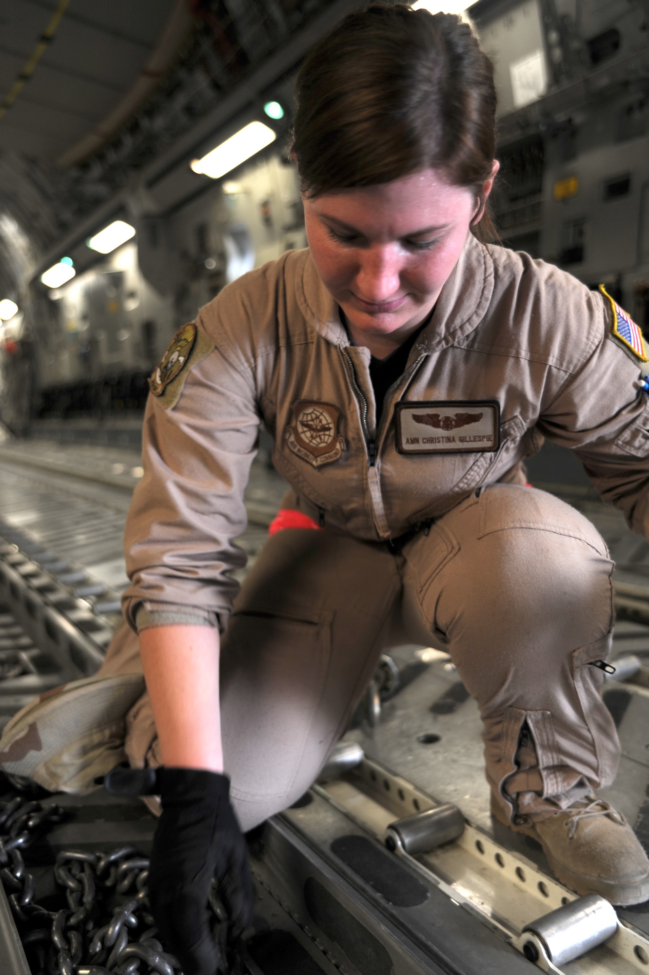 Airman Christina Gillespie prepares a C-17 Globemaster III for take-off at an undisclosed location in Southwest Asia on August 9. Airman Gillespie is a loadmaster with the 816th Expeditionary Airlift Squadron and is deployed from McChord AFB, WA. (U.S. Air Force photo/Senior Airman Katie Gieratz)