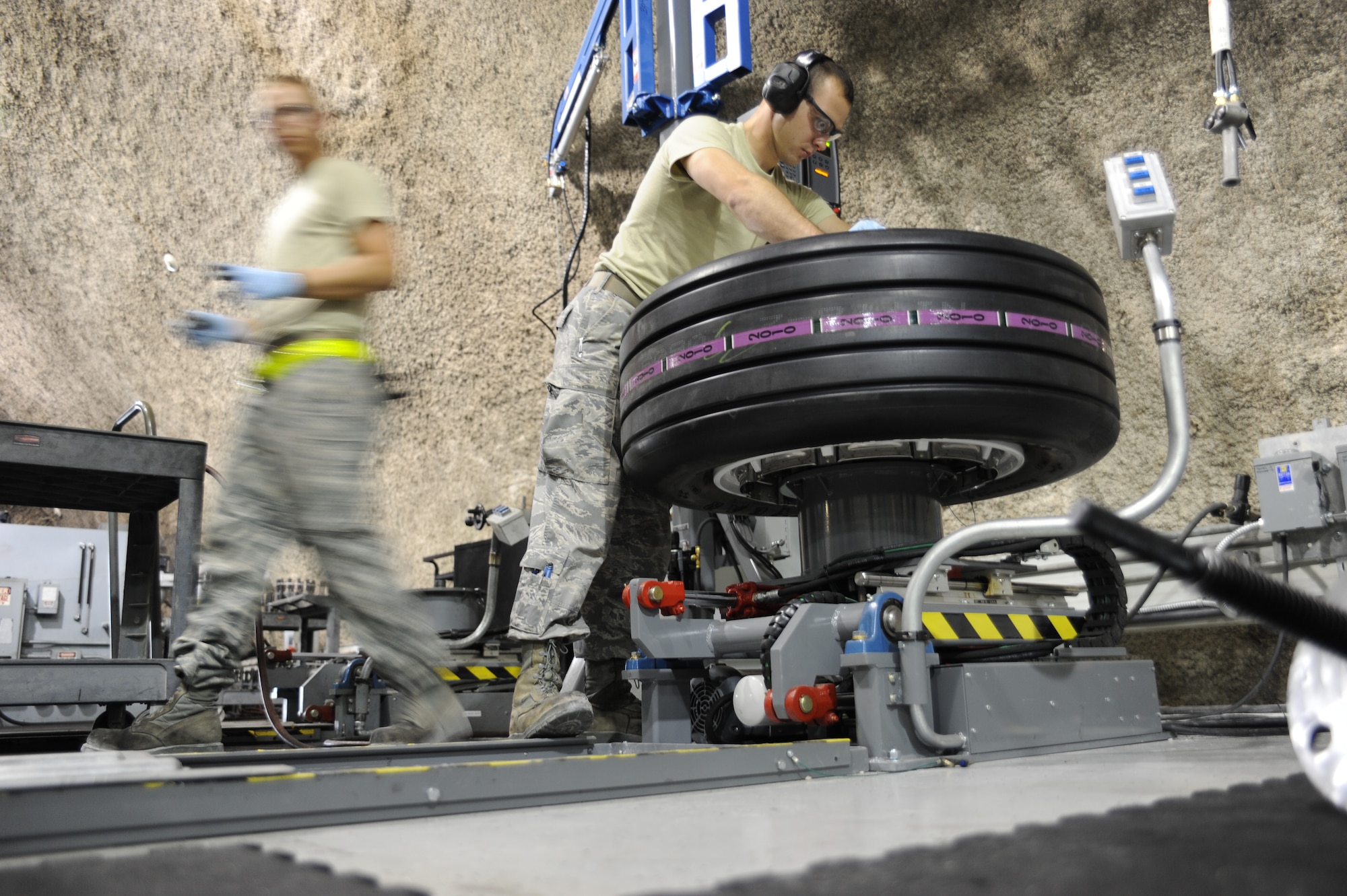 Wheel and tire airmen work on building up a tire at an undisclosed location in Southwest Asia August 1. (U.S. Air Force photo/Senior Airman Katie Gieratz)