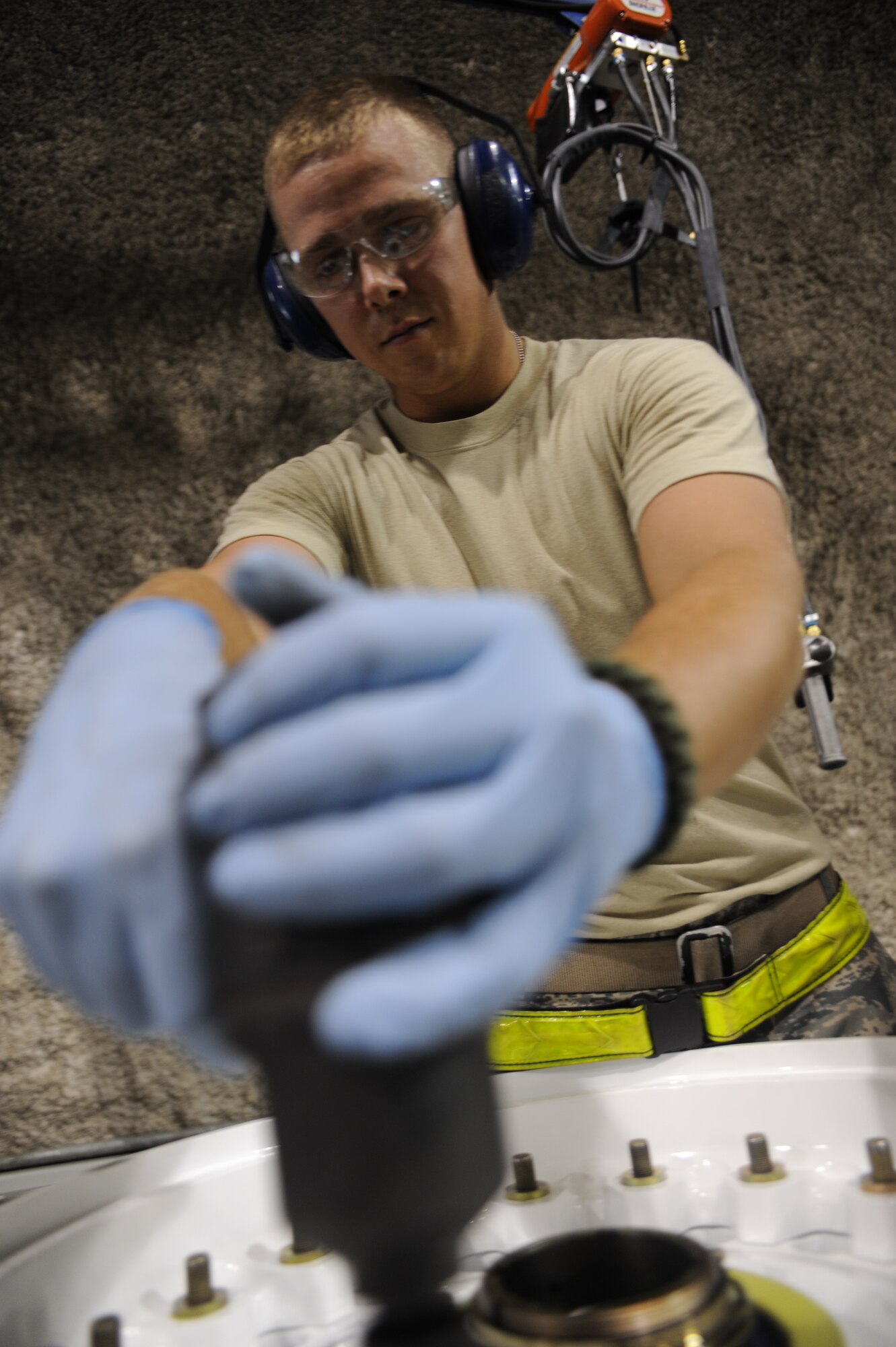 Senior Airman Brandon Ansbro works on building up a wheel at an undisclosed location in Southwest Asia August 1. Airman Ansbro is a wheel and tire journeyman with the 379th Expeditionary Maintenance Squadron and is deployed from Mildenhall, England. (U.S. Air Force photo/Senior Airman Katie Gieratz)