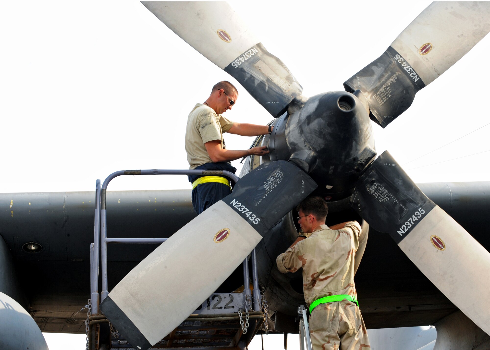 SOUTHWEST ASIA -- Tech. Sgt. Christopher Chadwell (left), checks the hydraulic fluid level on a C-130E propeller while Staff Sgt. William Aker inspects the engine inlet Aug. 11, 2010, at an undisclosed air base here. Sergeant Chadwell is an aerospace propulsion craftsman and Sergeant Aker is a flying crew chief. Both are assigned to the 386th Expeditionary Aircraft Maintenance Squadron, one of the busiest C-130 combat airlift and EC-130 electronic attack maintenance units in U.S. Air Forces Central Command. (U.S. Air Force photo by Senior Airman Laura Turner)
