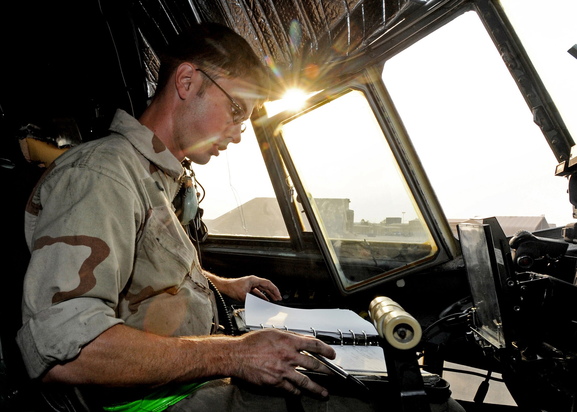 SOUTHWEST ASIA -- Staff Sgt. William Aker, a flying crew chief with the 386th Expeditionary Aircraft Maintenance Squadron, reviews maintenance logs prior to a max-power engine run on a C-130E Hercules at an undisclosed air base here Aug. 11, 2010. The 386 EAMXS is one of the busiest C-130 combat airlift and EC-130 electronic attack maintenance units in U.S. Air Forces Central Command. (U.S. Air Force photo by Senior Airman Laura Turner)