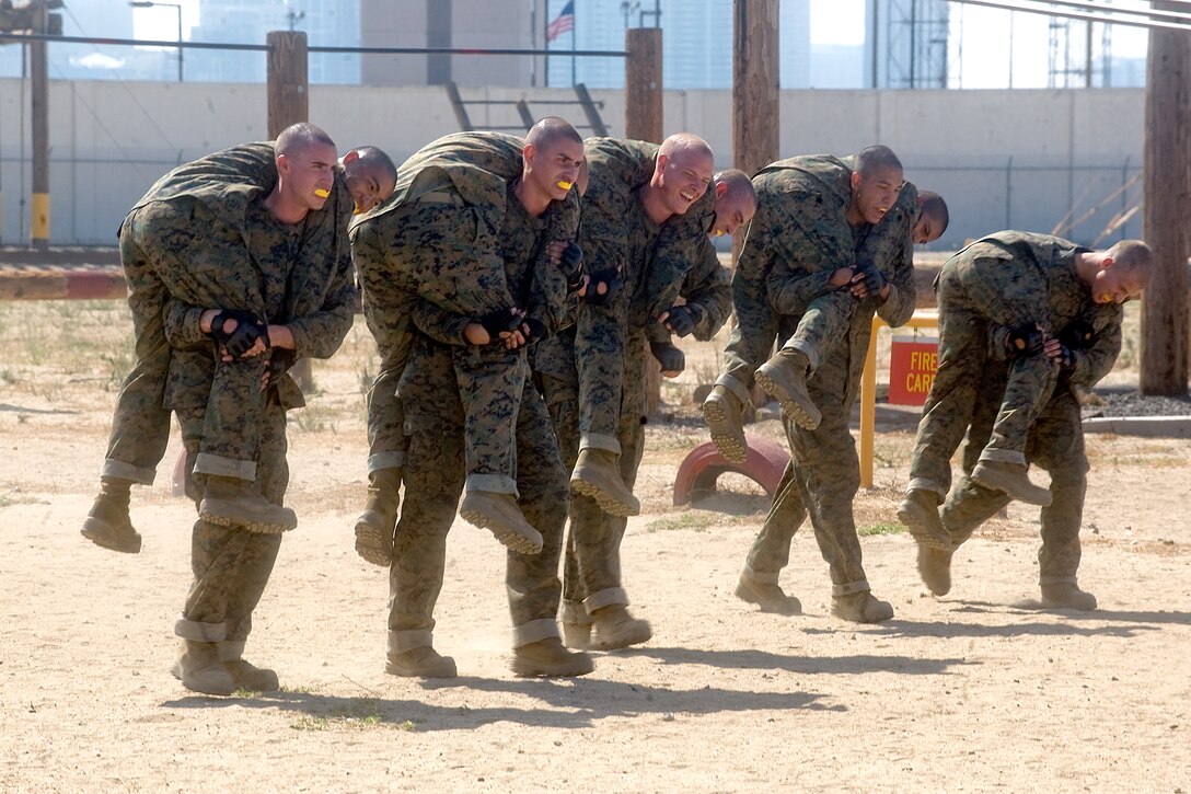 Defense Secretary Robert M. Gates observes Marine recruits carrying their cohorts at the Combat Conditioning Field, Marine Corp Recruit Depot in San Diego, Aug. 13, 2010.  