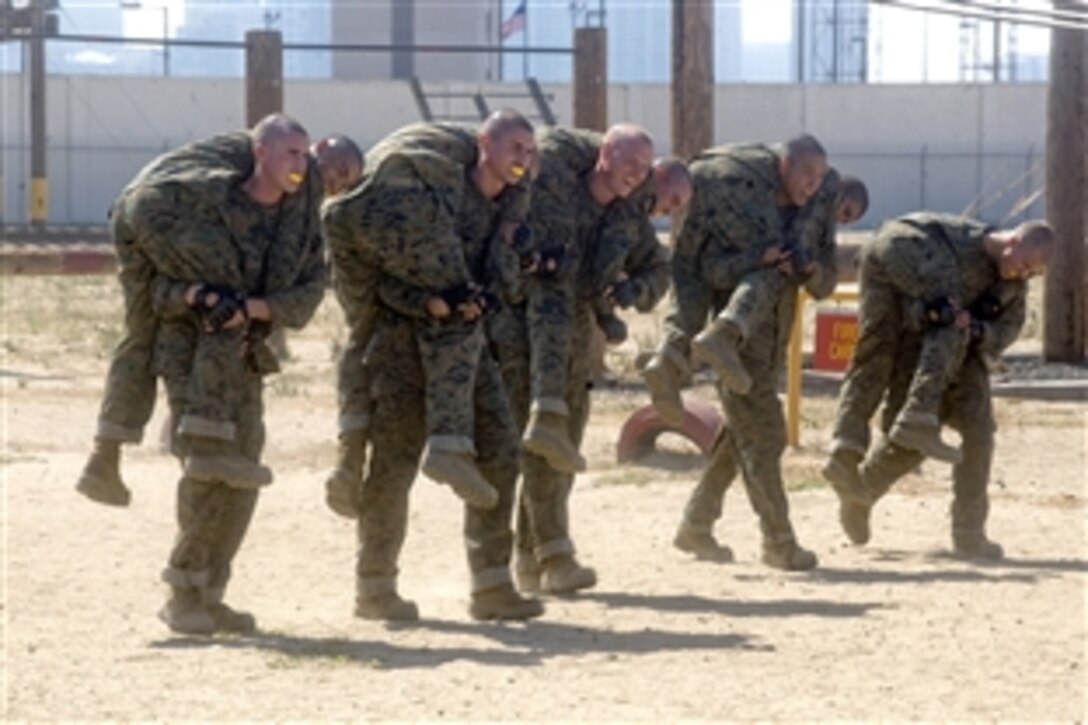 Marine recruits practice carrying their cohorts on the Combat Conditioning Field, Marine Corp Recruit Depot in San Diego, Aug. 13, 2010.  