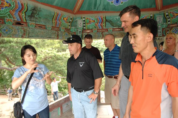 KUNSAN AIR BASE, Republic of Korea -- Choi Jung-Hyun, tour guide, explains the history of the Baekhwajeong Pavilion to Chief Master Sgts. James Sanders, 8th Fighter Wing command chief; Michael Adams, 8th Operations Group chief; and Choi Sang-Gi, 38th Fighter Group chief, during an 8th FW and 38th FG senior NCO culture tour Aug. 10. The tour gave the Wolf Pack and Republic of Korea Air Force members the opportunity to experience Korean culture while building the U.S. and ROKAF alliance. (Republic of Korea Air Force photo/Staff Sgt. Lee Jae-Sung) 