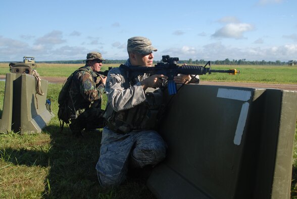 Tech. Sgt. Scott Bohlin of the 185th Air Refueling Wing Security Forces, covers forward troops during an Operational Readiness Exercise at Volk Field, Wiscosin, 11 August, 2010. (US Air Force Photo by Tech. Sgt. Brian Cox) 