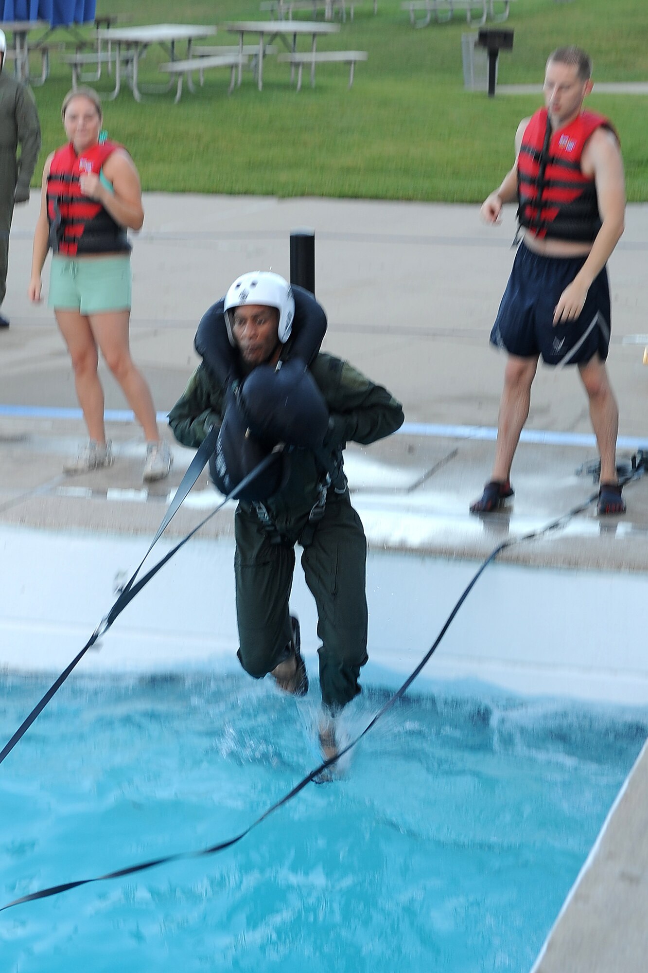 Col. Leonard Isabelle, commander of the 127th Operations Group, is pulled into the water as part of his water survival refresher training, Aug. 15, 2010. During the training, pilots from Selfridge Air National Guard Base were pulled into the wave pool at Red Oaks Water Park in Madison Heights, Mich., to simulate the pull of a parachute. The pilots then had to extricate themselves from the parachute harness. The pilots are required to undergo the water survival training once every three years. (U.S. Air Force photo by TSgt. Dan Heaton) (RELEASED)