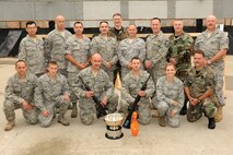 174th Rifle Team members pose with: Master Sgt. Paul Cowan, Technical Sgt. Christopher Ashley, Senior Airman Tonya Ward and Senior Airman Andrew LaFave Pose with Awards they earned as a team participating in the Annual TAG match held at Camp Smith Peekskill New York. The four person team earned the overall Team Rifle Champion Cup. (US Air Force photo by Staff Sgt. James N. Faso II/Released)
