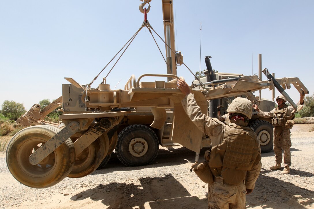 Marines with Combat Logistics Battalion 5, 1st Marine Logistics Group (Forward), use a crane to recover a mine roller during a combat logistics patrol in Helmand province, Afghanistan, Aug. 15. If a vehicle or mine roller becomes stuck or damaged while on a combat logistics patrol, a wrecker team assists in recovering the vehicle.