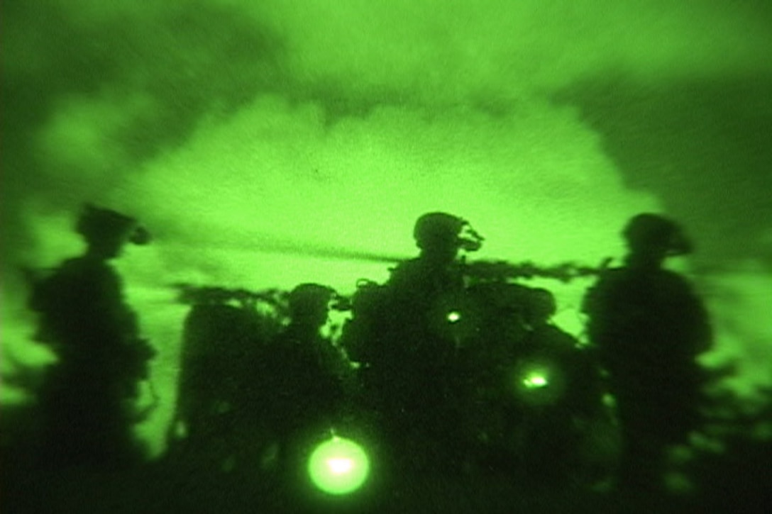 Marines with the 31st Marine Expeditionary Unit move to their objective during a Maritime Contingency Force Raid at Kadena Training Area 1, Aug. 16. The raid was in support of the MEU's upcoming fall patrol.