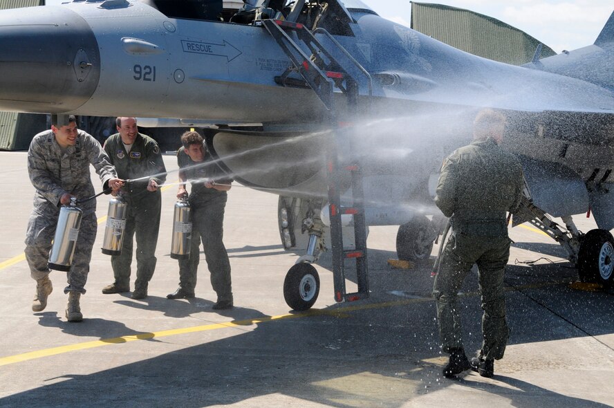 MISAWA AIR BASE, Japan -- Capt. Alan Haedge, 35th Fighter Wing executive officer, far left, Lt. Col. Anthony Retka, 35th Fighter Wing chief of safety, and Lt. Col. David Youtsey, 35th Operations Group command deputy, ambush Col. RC Craig, 35th Fighter Wing Commander, with fire extinguishers following his final flight at Misawa, Aug. 13. This is a common gesture of farewell to pilots before they move on to other bases. (U.S. Air Force photo/1st Lt. Jeffre Nagan)