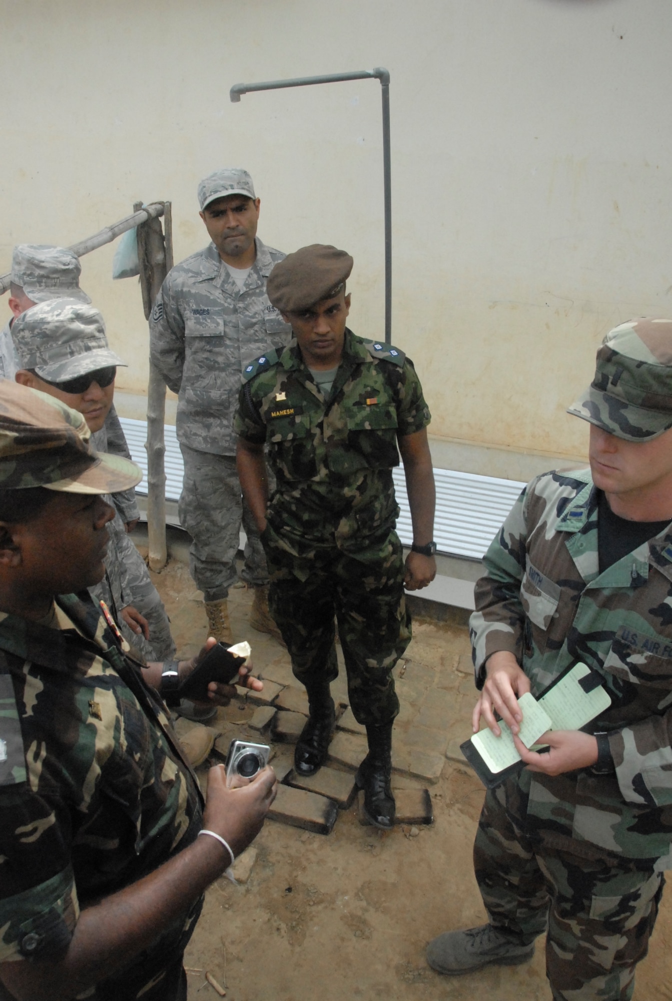 U.S. Air Force 1st Lt. Logan Smith discusses plans to improve an outdoor shower with Sri Lankan Army officials prior to beginning work on a school in Puttalam Township, Sri Lanka,  on Aug. 16, 2010. Lieutenant Smith and more than 40 servicemembers joined Sri Lankan, Maldives, and Mongolian representatives in participating in Pacific Angel-Sri Lanka. Operation Pacific Angel is a joint and combined humanitarian assistance operation conducted in the Pacific area of responsibility to support U.S. Pacific Command's capacity-building efforts. This humanitarian and civic assistance program is aimed at improving military civic cooperation between the United States and countries throughout the Asia-Pacific region. Pacific Angel 2010 is scheduled through August 22. (U.S. Air Force photo/Master Sgt. Mike Hammond)