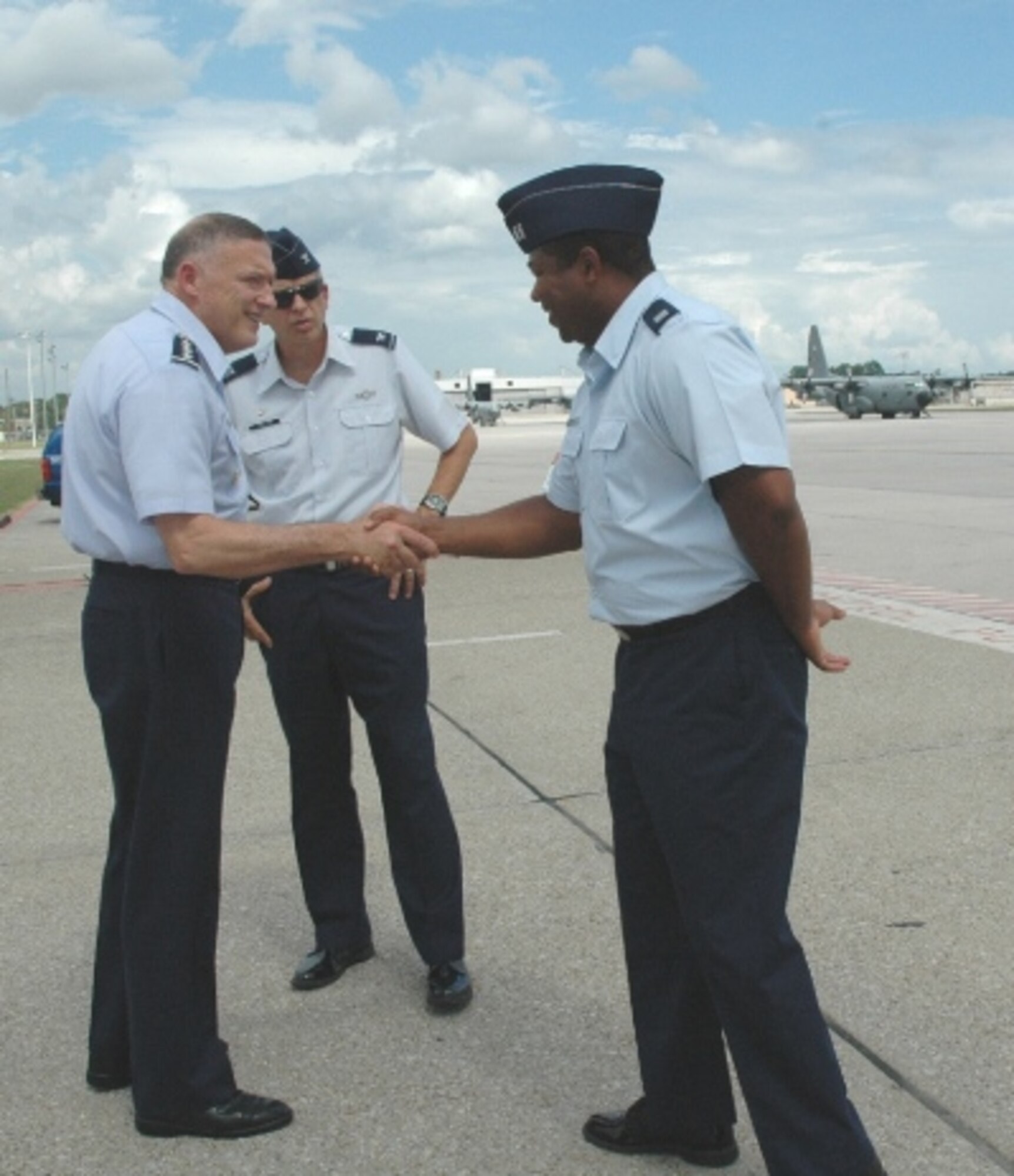 Gen. Gary North, Pacific Air Forces commander, meets Capt. Quincy Hudson, 94th Airlift Wing executive officer as Col. Timothy Tarchick, 94 AW and Dobbins Air Reserve Base commander, looks on during the general’s visit to the Atlanta area Aug. 16.  (U.S. Air Force photo/J.D. Marckmann)