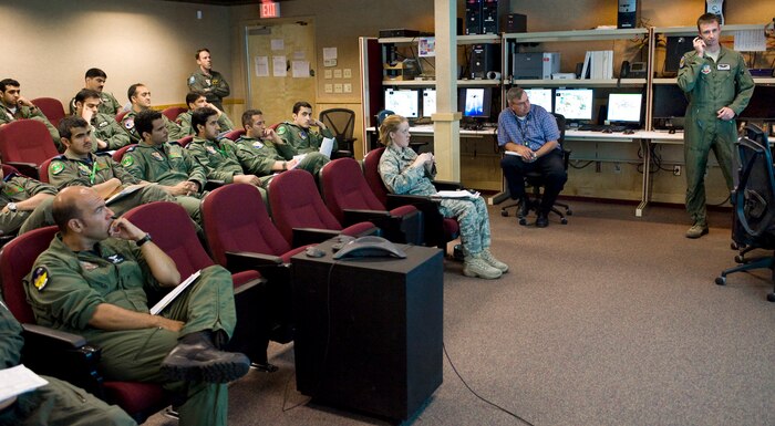 NELLIS AIR FORCE BASE, Nev.-- Capt. Andy Labrum, close air support instructor, 549th Combat Training Squadron, oversees a debrief session between U.S., Royal Saudi Arabia and Pakistan Air Force pilots and joint terminal attack controllers after a training mission during Green Flag West 10-9 exercise.  The coalition aircraft launch from Nellis AFB and fly to the National Training Center in Fort Irwin, Calif. to train on close air support during Green Flag-West.  The exercise provides a realistic air-land integration training environment for joint forces preparing to support worldwide combat operations. (U.S. Air Force Photo by Lawrence Crespo)

