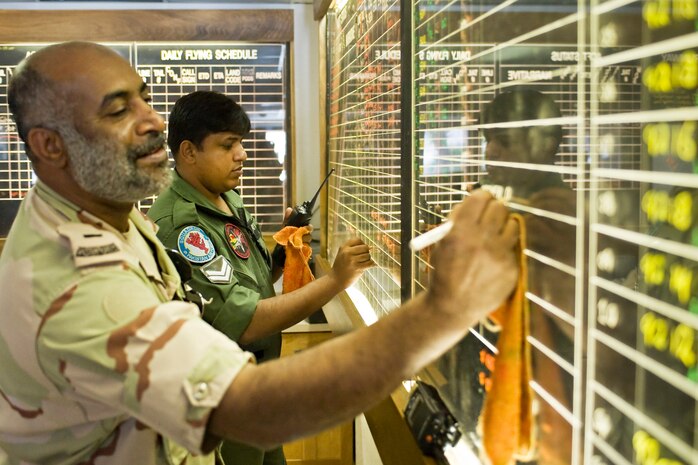 NELLIS AIR FORCE BASE, Nev.-- Royal Saudi and Pakistan Air Force members update their prospective flight line status boards at the Green Flag maintenance operation center during the Green Flag West 10-9 exercise at Nellis Aug. 11. The MOC controllers ensure a smooth transition of all the maintenance activities during daily flying operations. Green Flag-West provides a realistic air-land integration training environment for joint forces preparing to support worldwide combat operations. (U.S. Air Force Photo by Lawrence Crespo)


