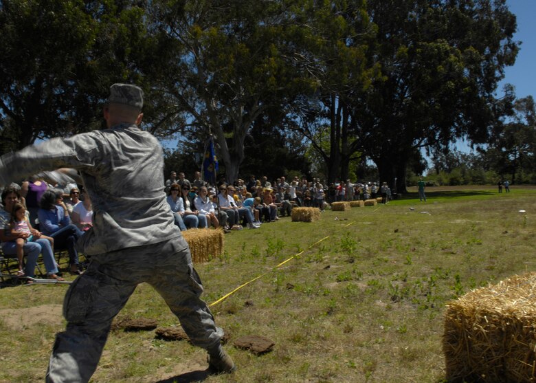 VANDENBERG AIR FORCE BASE, Calif. – Lt. Col. Michael Dombrowski, the Operations Group deputy commander, winds up to throw his cow pie discus during the 22nd Annual Texas Blowout at Cocheo Park here Friday, Aug. 13, 2010. The 30th Space Wing Staff Agencies decorated a dried cow pie for their respective commanders in order to participate in the cow pie toss contest which will raise money for Vandenberg’s Operation Kids Christmas event. (U.S. Air Force photo/Airman 1st Class Lael Huss)
