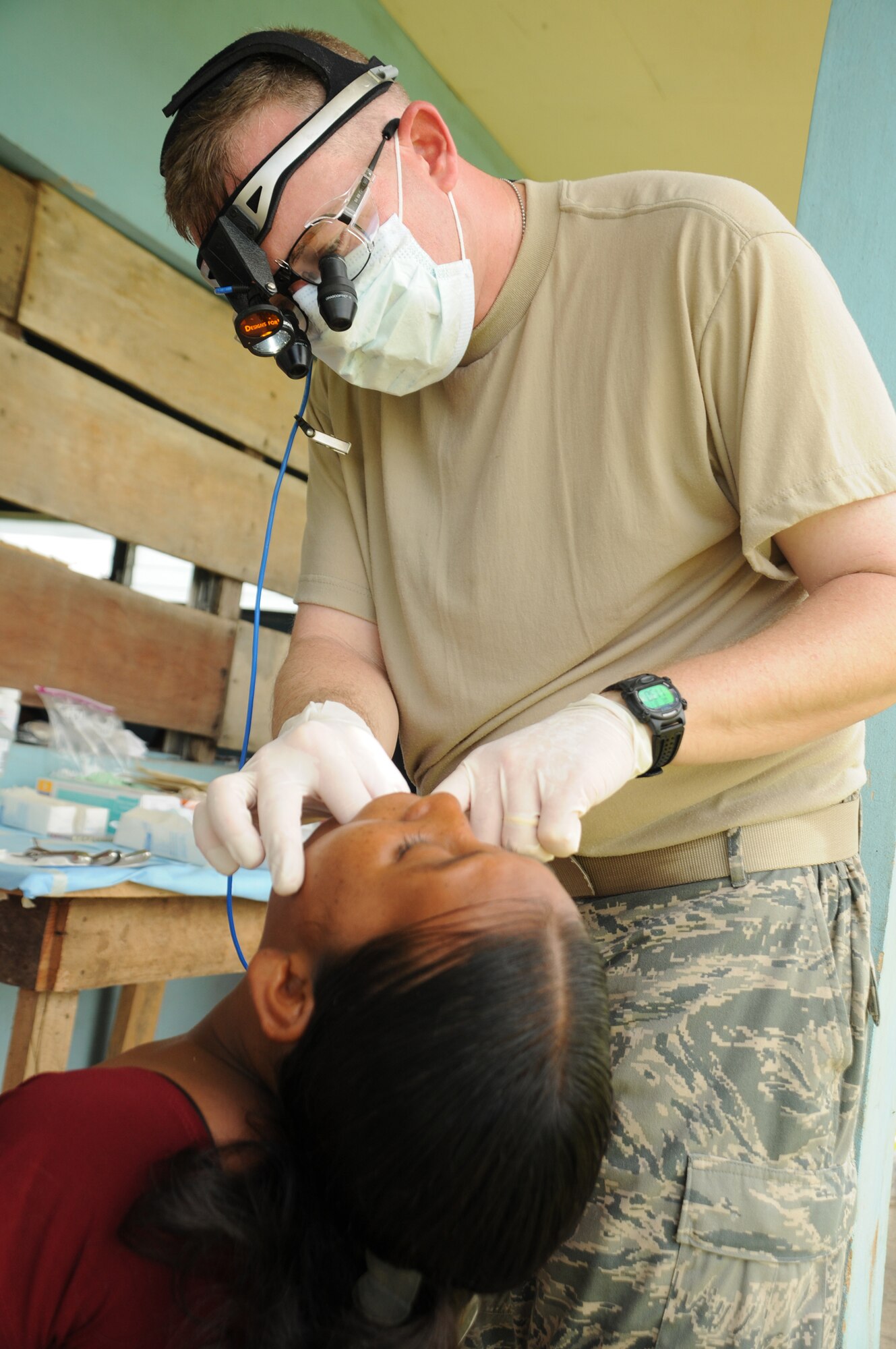 YAPUWAS, Honduras --  Lt. Col. Thomas Edmonson, a dentist with the Medical Element at Soto Cano Air Base, inspects a patients mouth before an extraction during the medical civic action program here Aug. 11. Colonel Edmonson, along with Honduran military and civilian dentists, conducted more than 100 extractions over the four-day MEDCAP. (U.S. Air Force photo/Tech. Sgt. Benjamin Rojek)