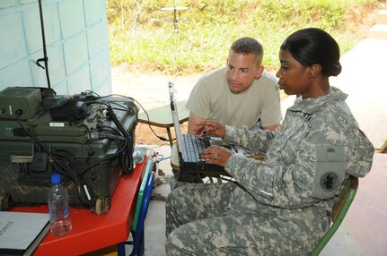 YAPUWAS, Honduras -- Tech. Sgt. Kenneth Dewey, a communications technician with Joint Task Force-Bravo, and Maj. Erica Jackson, the JTF-Bravo Army Forces S-3,  make contact with the tactical operations center at the National University of Agriculture in Catacamas, Honduras, during the medical civic action program here Aug. 11. The MEDCAP team visited three villages during the four-day mission, but stayed as guests at the university during that time. (U.S. Air Force photo/Tech. Sgt. Benjamin Rojek)