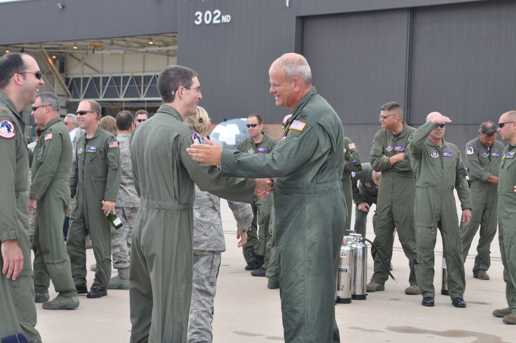Col. Bob Chapman (right) is congratulated by Lt. Col. Harold Treffeisen, a C-130 Hercules pilot assigned to the 731st Airlift Squadron, after completing his final flight Aug. 8 at Peterson Air Force Base, Colo. This was the Air Force Reserve colonel's final flight with the 302nd AW, which culminated his military flying career with more than 5,200 hours of flight, including over combat zones. Colonel Chapman, who relinquished his position as the wing's vice commander during the August unit training assembly, has served in the Air Force since 1978 when he joined as an enlisted member. The colonel left Active Duty in 1992, becoming an Air Force Reserve member with the 302nd AW. During that time, he commanded the 731st AS during a deployment to the Middle East and during numerous aerial firefighting activations. The colonel is projected to retire in March 2011. (U.S. Air Force photo/Ann Skarban)