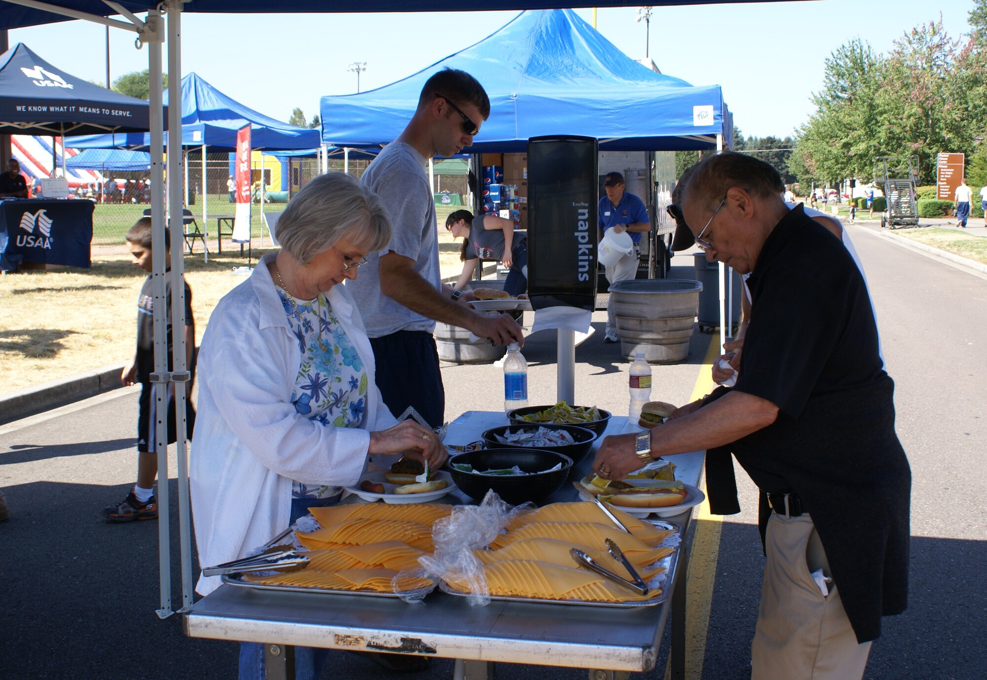 Servicemembers and families take a break from the activites to eat lunch during the McChord Field Family Sports Day Aug. 13.(U.S. Air Force Photo/Amn Leah Young)