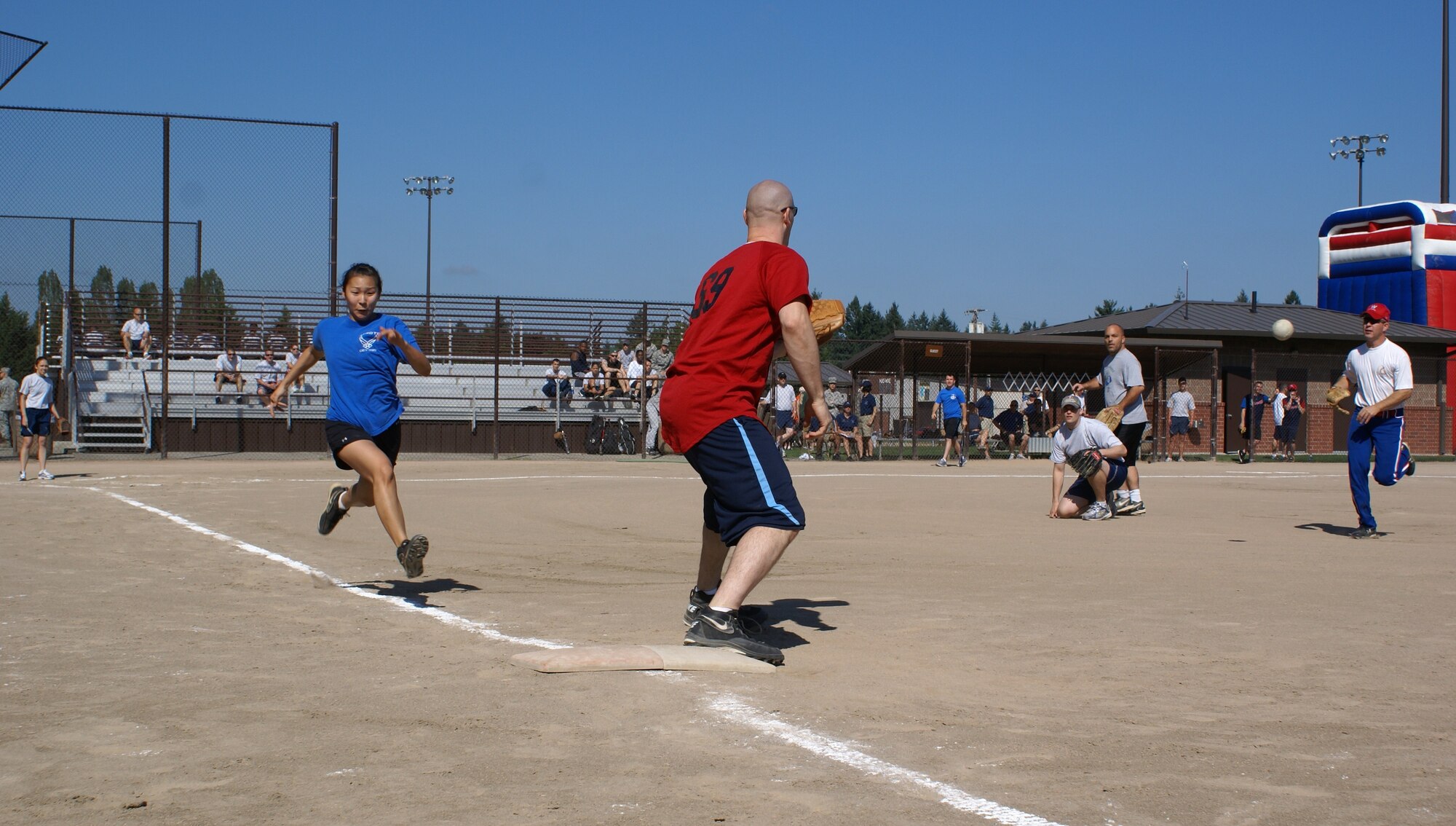 Servicemembers from the Aerial Port Squadron and 7th Airlift Squadron compete in a softball game at McChord Field Family Sports Day Aug. 13(U.S. Air Force Photo/Amn Leah Young)