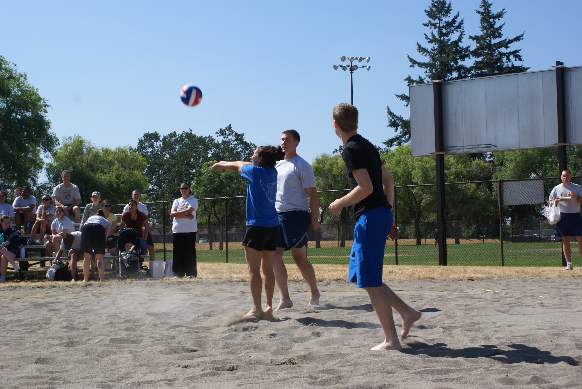 Servicemembers from the 7th Airlift Squadron and the 62d Airlift Wing Maintenance Squadron compete in a volleyball game at McChord Field Family Sports Day Aug. 13(U.S. Air Force Photo/Amn Leah Young)