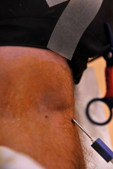 MOODY AIR FORCE BASE, Ga. -- A needle is placed in the arm of an Airman during the American Red Cross blood drive here Aug. 12. (U.S. Air Force photo by Airman 1st Class Joshua Green/RELEASED)