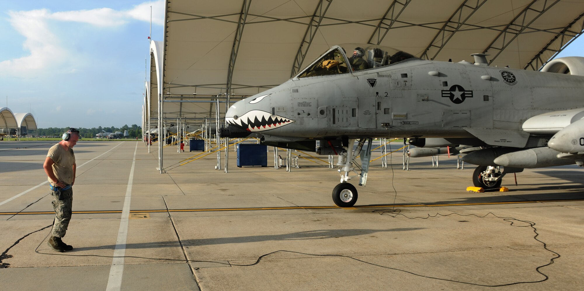 MOODY AIR FORCE BASE, Ga. -- Staff Sgt. Sean Carroll, 74th Aircraft Maintenance Unit crew chief, communicates with  Capt. Brendhan Goss, 74th Fighter Squadron A-10C Thunderbolt II instructor pilot, through a headset as they both go over the final details of the preflight check list before takeoff here Aug. 13. Aircraft maintainers like Sergeant Carroll, traveled to Yuma, Ariz., to ensure that the A-10C will provide close air support during the entire Enhanced Mojave Viper Exercise. (U.S. Air Force photo by Airman 1st Class Benjamin Wiseman/RELEASED)