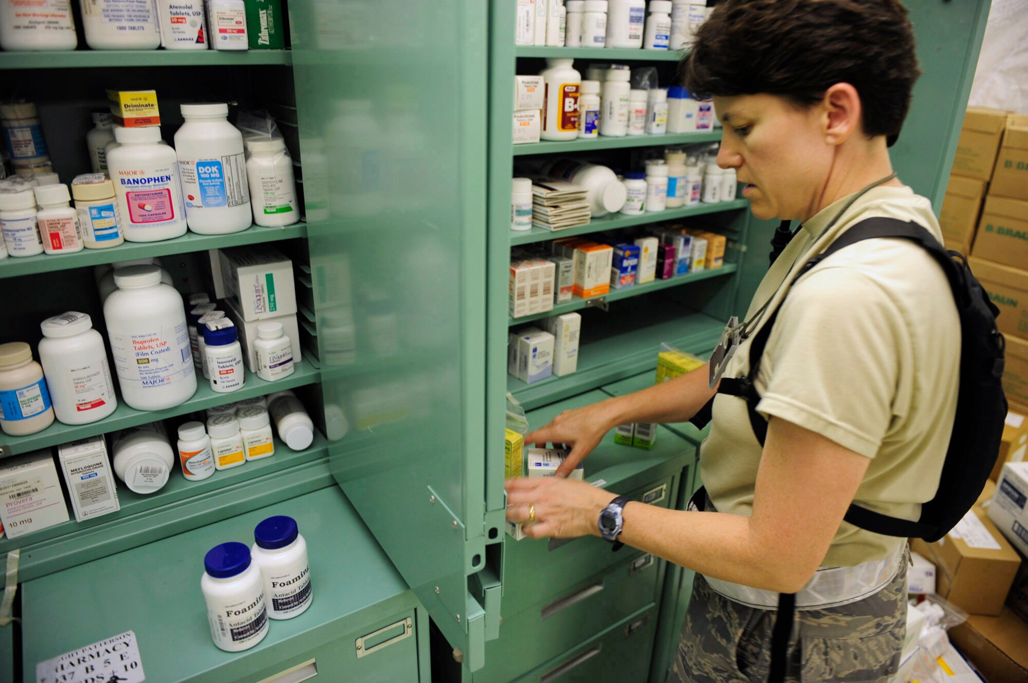 Maj. Vina Howarth stores pharmaceutical supplies in the expeditionary medical support tent during exercise Vibrant Response July 14, 2010, at Camp Atterbury, Ind. Major Howarth is assigned to the 59th Pharmacy Squadron. (U.S. Air Force photo/Airman 1st Class Samuel W. Goodman)