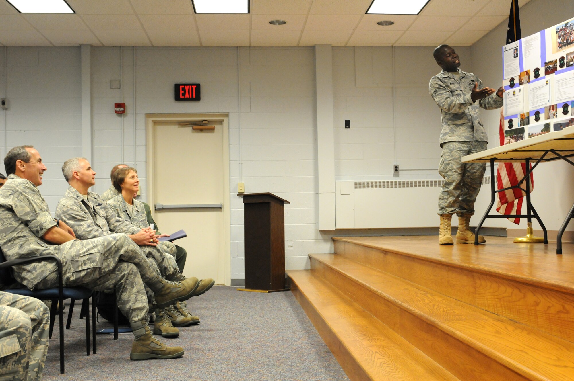 JOINT BASE ANDREWS, Md. -- Senior Airman Clement Addo (far right), 459th Aerospace Medicine Squadron, provides a briefing about his squadron to Gen. Raymond E. Johns Jr. (far left), Air Mobility Command commander, during a visit to the 459th Air Refueling Wing here Aug. 14. General Johns toured facilities and met with 459th ARW Airmen during his visit. (U.S. Air Force photo/Tech Sgt. Steve Lewis)