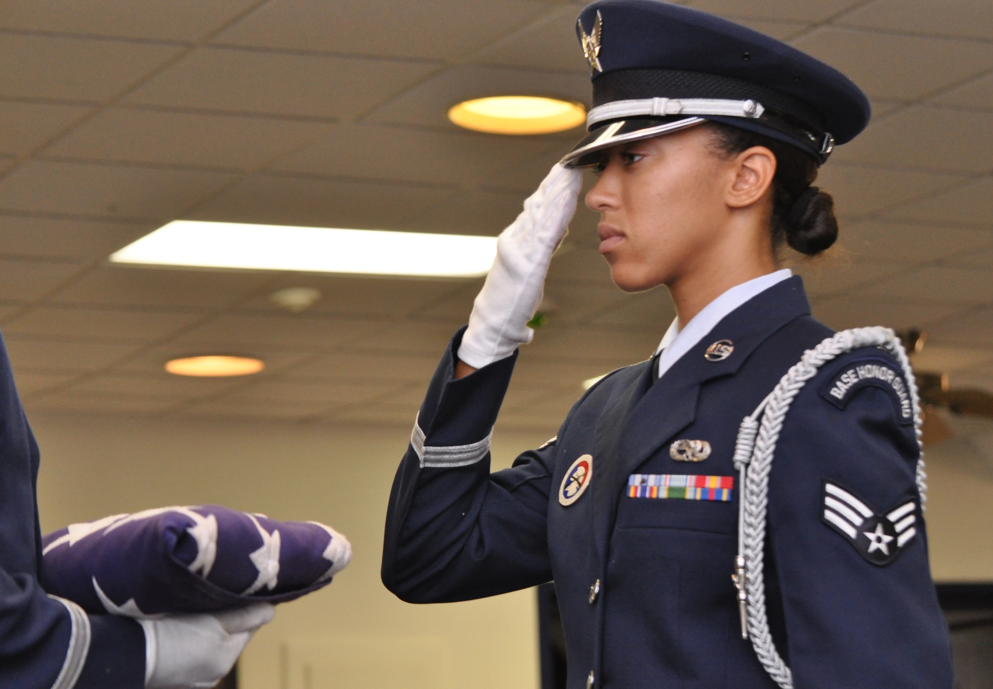 BARKSDALE AIR FORCE BASE, La. - Senior Airman Ciarra Shady salutes the U.S. flag while practicing for a retirement ceremony.  Airman Shady is the 2009 Chief Master Sergeant of the Air Force base honor guard member of the year. (U.S. Air Force photo/Master Sgt. Corey A. Clements)