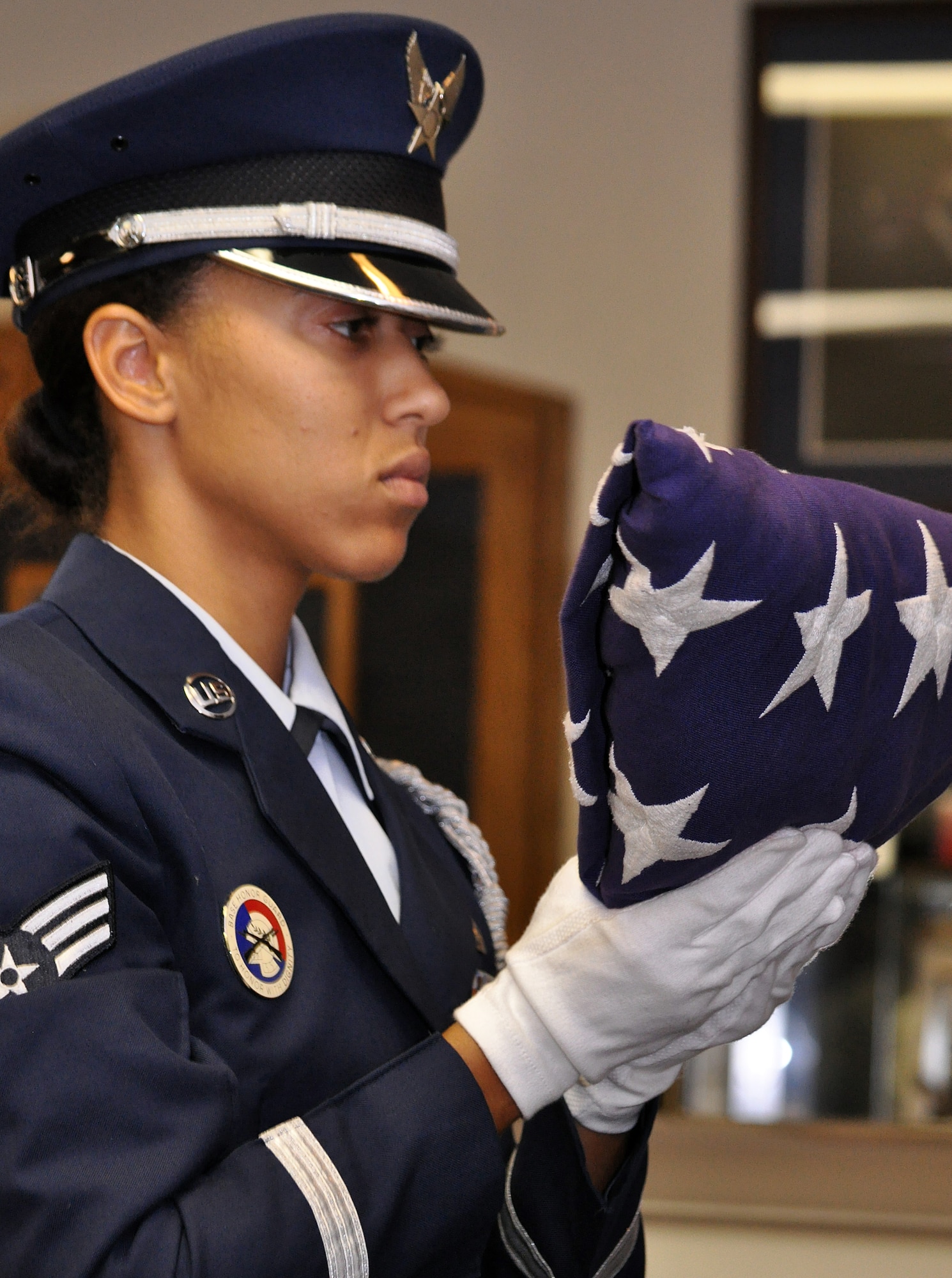 BARKSDALE AIR FORCE BASE, La. - Senior Airman Ciarra Shady dresses the U.S. flag while practicing for a retirement ceremony.  Airman Shady is the 2009 Chief Master Sergeant of the Air Force base honor guard member of the year. (U.S. Air Force photo/Master Sgt. Corey A. Clements)