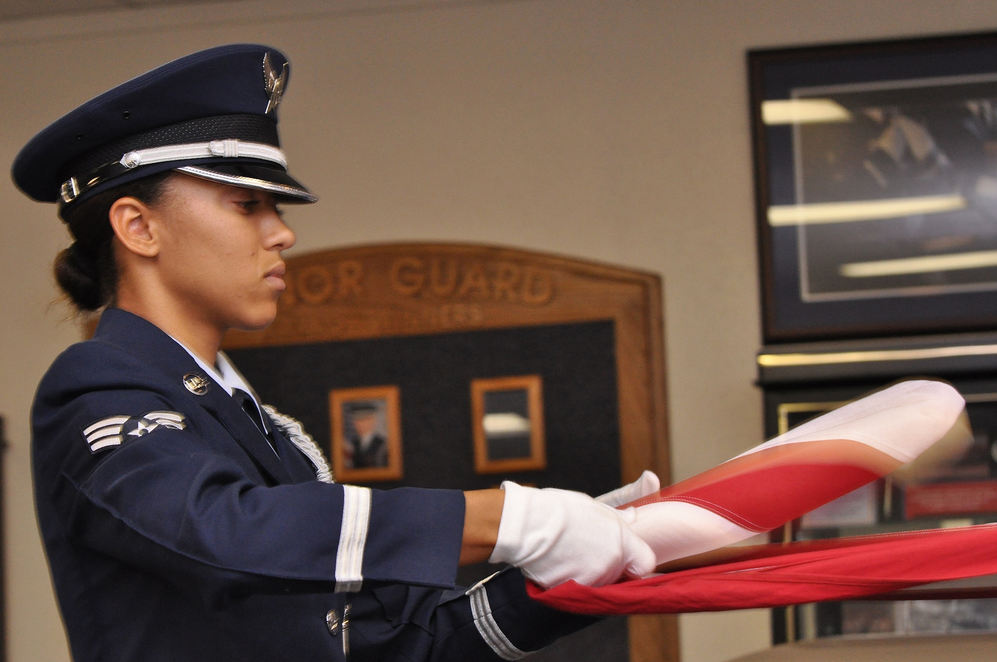 BARKSDALE AIR FORCE BASE, La. - Senior Airman Ciarra Shady folds the U.S. flag during a dress rehearsal for a retirement ceremony.  Airman Shady is the 2009 Chief Master Sergeant of the Air Force base honor guard member of the year. (U.S. Air Force photo/Master Sgt. Corey A. Clements)