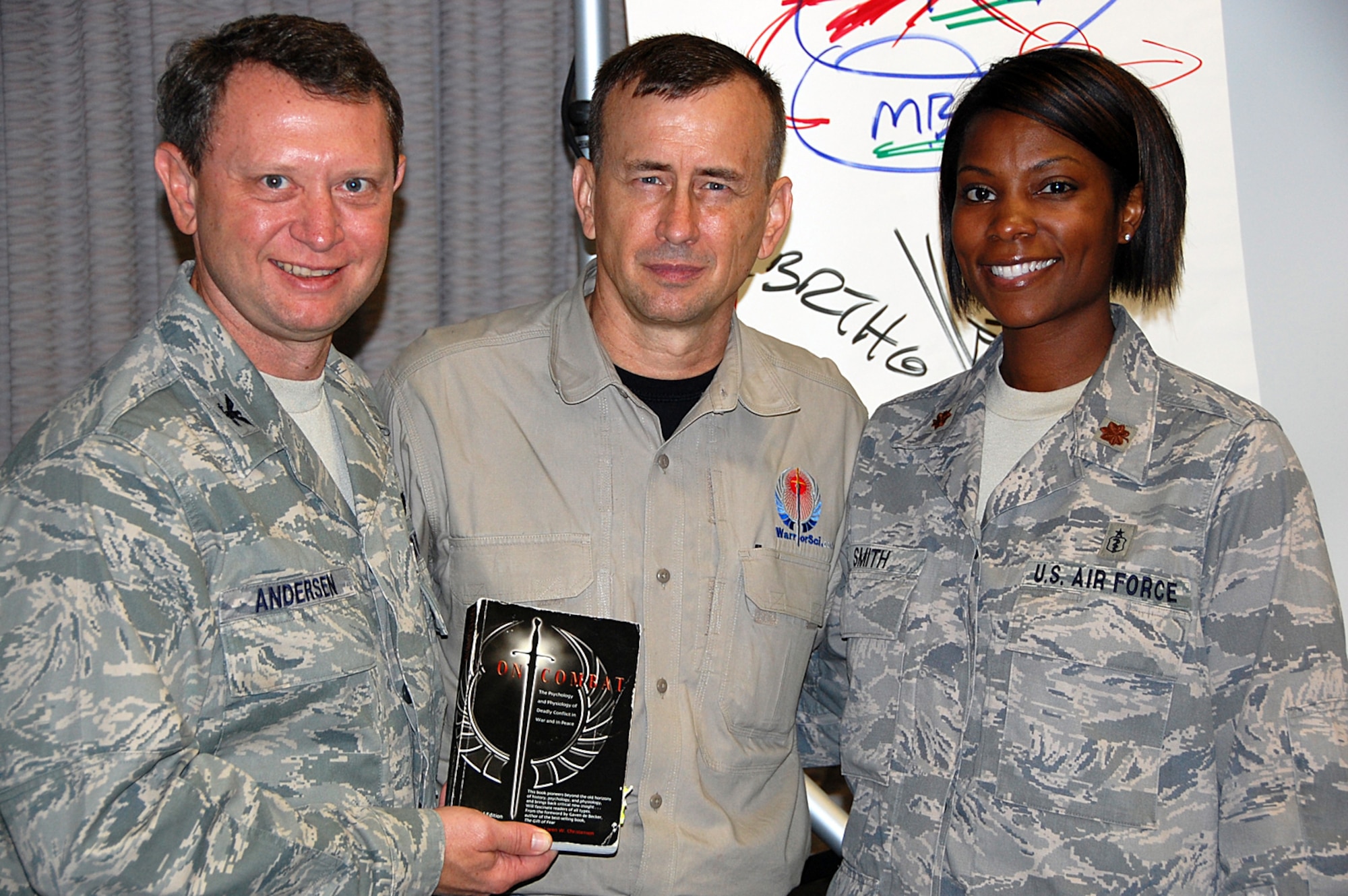 Col. William Andersen, U.S. Air Force Special Operations School commandant, left, and Maj. Shanda Smith, a psychiatrist assigned to the 96th Medical Group at Eglin Air Force Base, Fla., right, pose with retired U.S. Army Lt. Col. Dave Grossman, former U.S. Military Academy psychology professor and U.S. Army Ranger, at the U.S. Air Force Special Operations School auditorium at Hurlburt Field, Fla., Aug. 11, 2010. Colonel Grossman presented his lecture entitled “The Bulletproof Mind: Mental Preparation for Combat” about the conditions one may expect while in combat, including factors related to post-traumatic stress disorder and the process of healing in today’s environment. (Courtesy photo) 