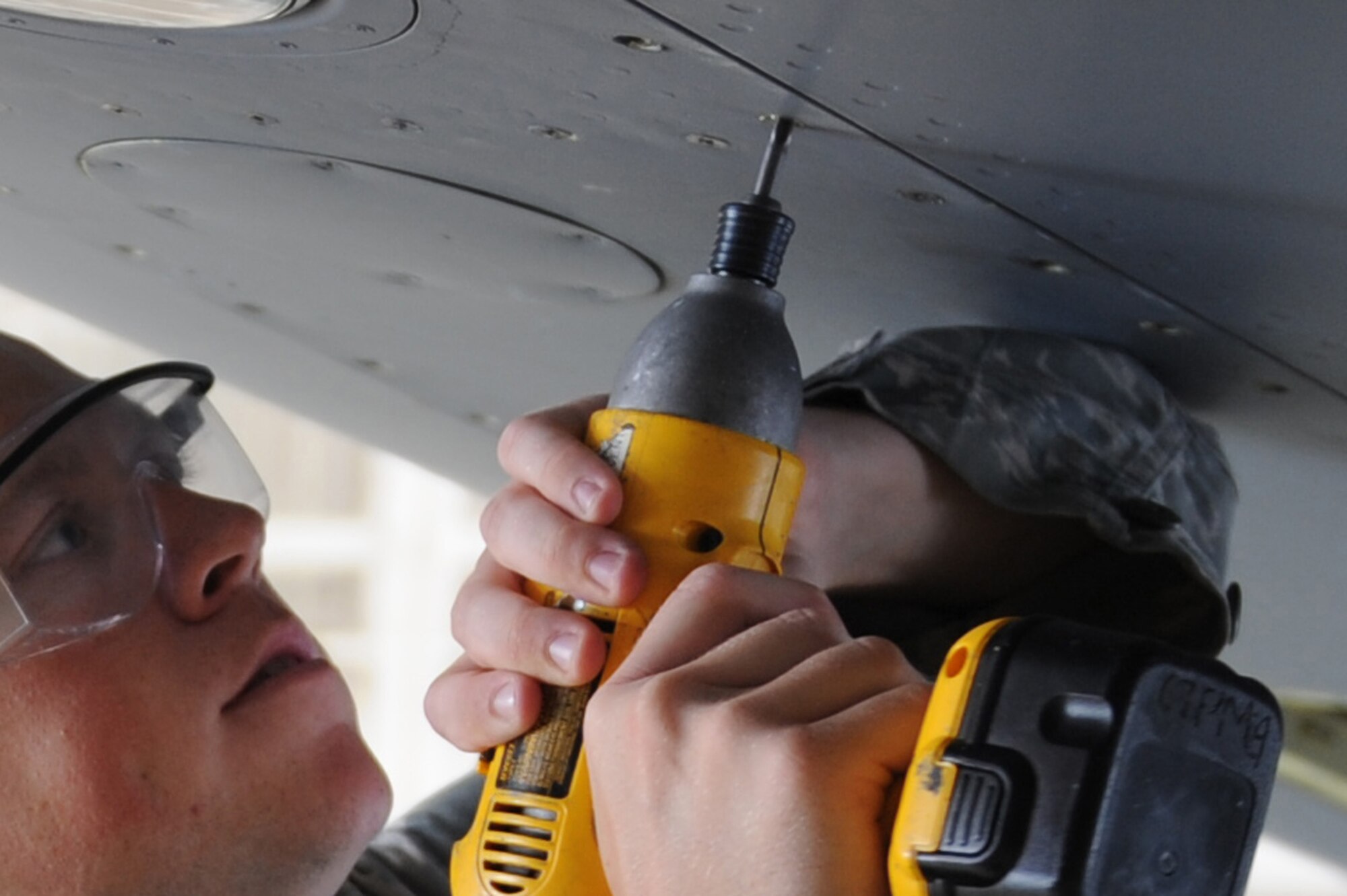 Staff Sgt. Michael Mahaney, 906th Air Refueling Squadron, tightens down a leading edge panel on a KC-135 Stratotanker at Scott AFB, July 20, 2010. The panel was removed as part of a slat inspection for a pressure check on the aircraft. Sergeant Mahaney is an active duty member working alongside the Air National Guard of the 126th Air Refueling Wing as part of joint effort between active and guard units to keep the KC-135?s flying. (U.S. Air Force photo by Staff Sgt. Brian J. Ellis)