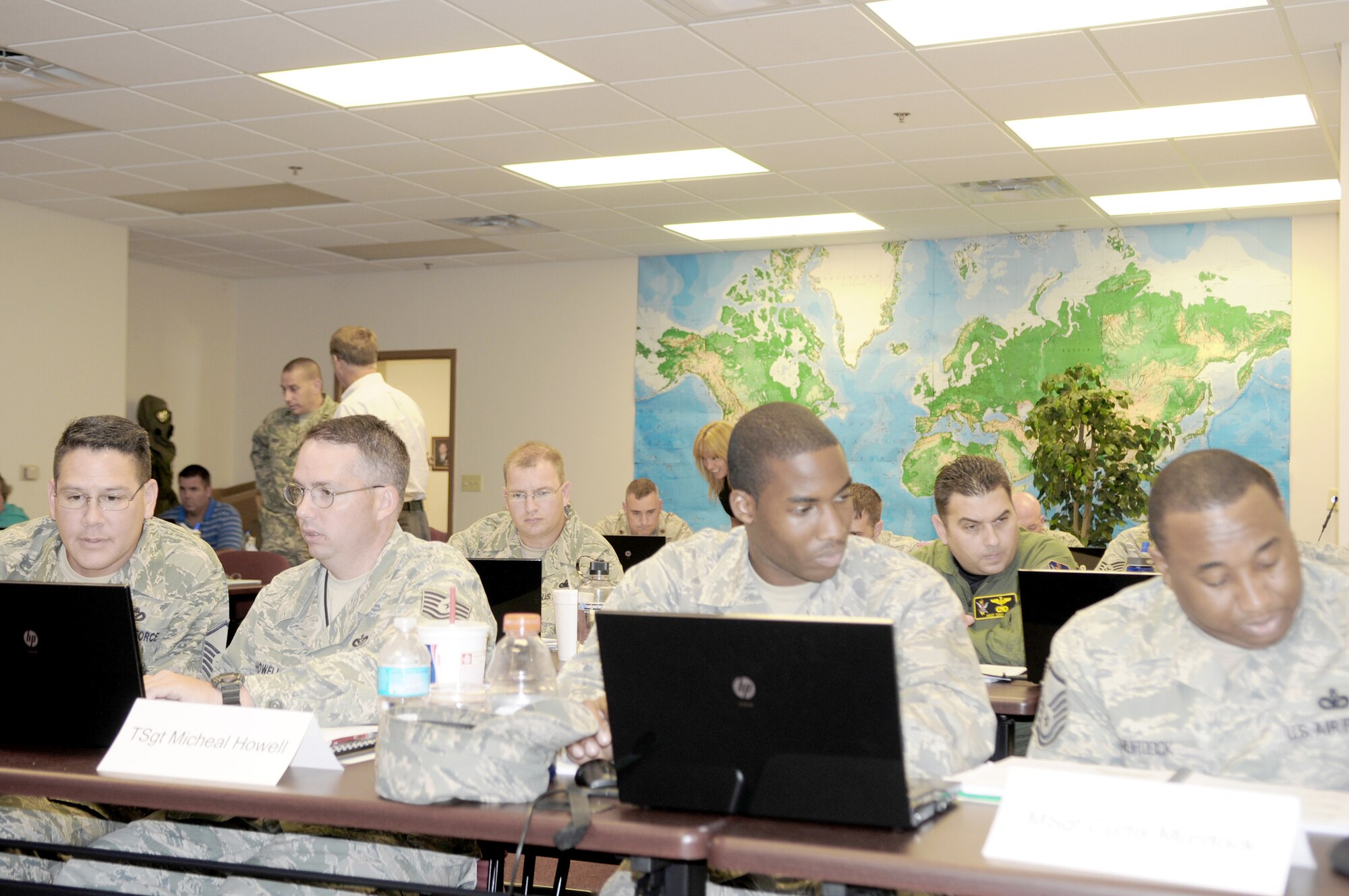 Instructors help students during the Integrated Defense Risk Management Process and ForcePRO workshop being held at Moody Air Force Base, Ga., July 30, 2010. Students worked together in teams to answer and complete classroom exercises in designated time periods. (U.S. Air Force photo/Tech. Sgt. Patrick Hyde)