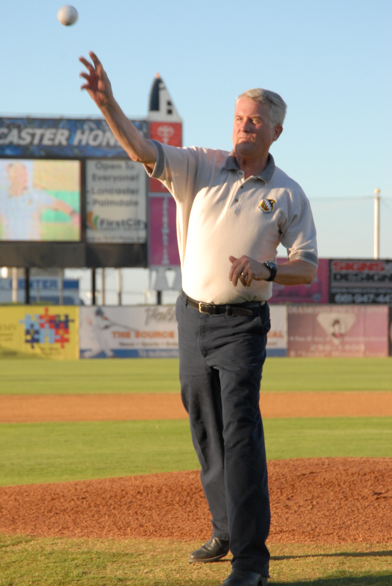 Maj. Gen. David J. Eichhorn, Air Force Flight Test Center commander, throws one of the ceremonial first pitches before the annual Lancaster JetHawks' Aerospace Appreciation Night game Aug. 14.  General Eichhorn joined Former NASA astronaut Robert "Hoot" Gibson. Edwards Air Force Base Civilian Military support group hosted military and civilian members from Edwards for the Saturday night event. (Air Force photo by Meredith Mingledorff)