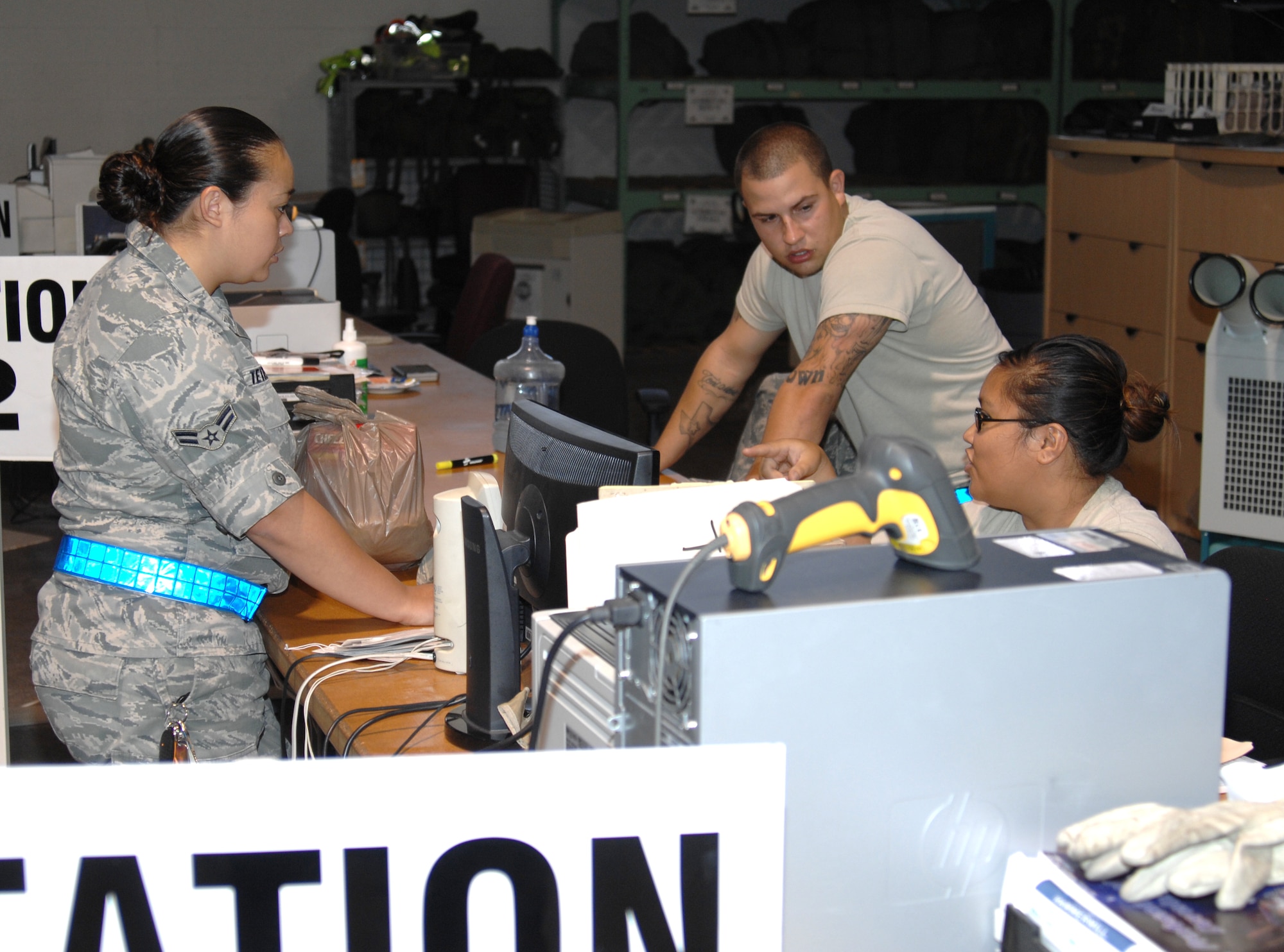 Senior Airman Sharon Dugger, (right) 22nd Logistics Readiness Squadron individual protective equipment journeyman, gives turnover to Airman 1st Class Megan Tetreault, 22nd Logistics Readiness Squadron individual protective equipment journeyman, during an exercise, Aug. 15, 2010, McConnell Air Force Base, Kan.  Airmen at IPE maintain mobility equipment for Airmen deploying across the world. (U.S. Air Force photo/Staff Sgt. Ronald Lafosse)